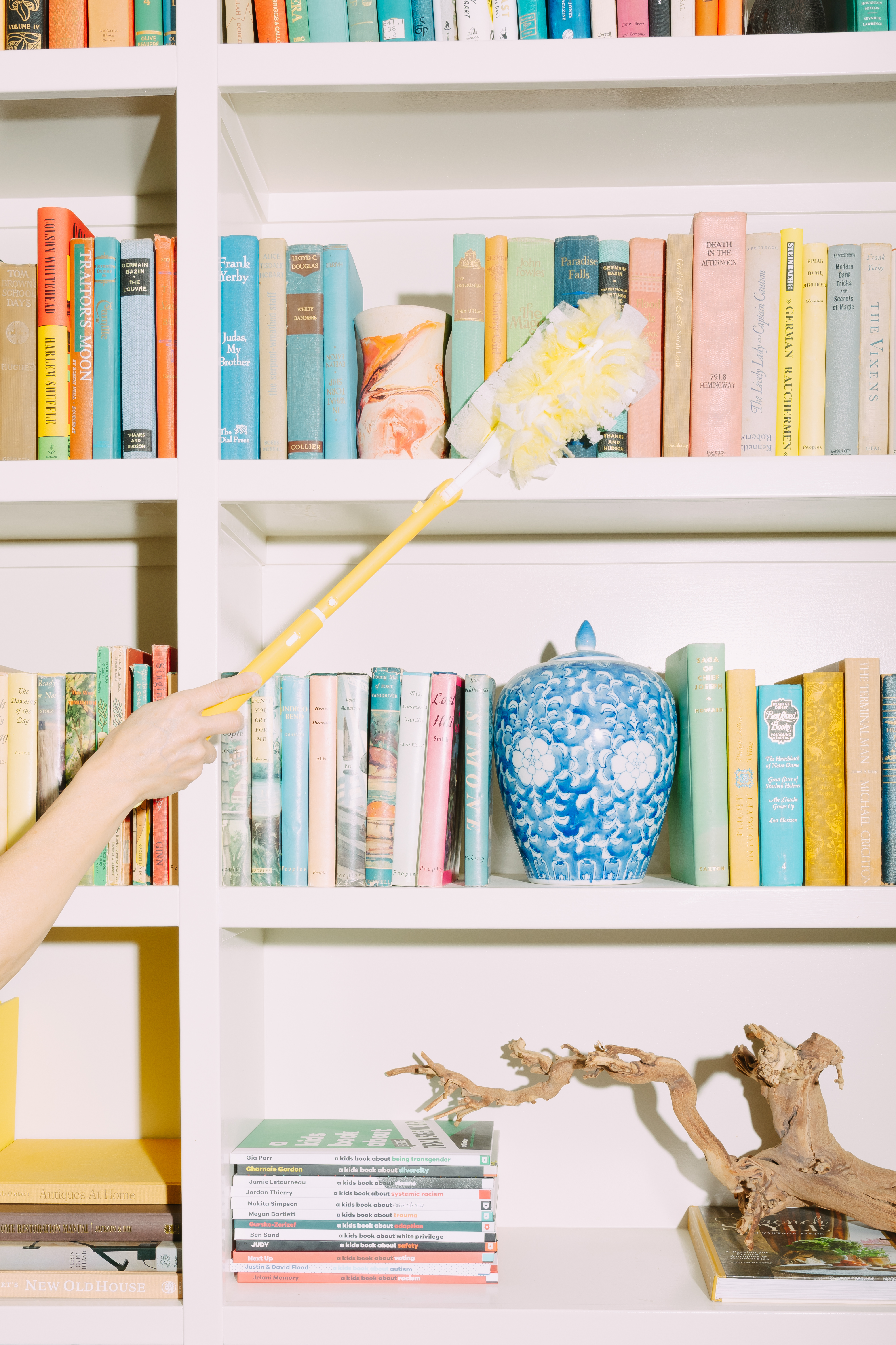 True Glow team member dusting a bookshelf